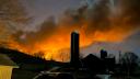 A train fire is seen from a farm in East Palestine, Ohio, on Feb. 3, 2023. 